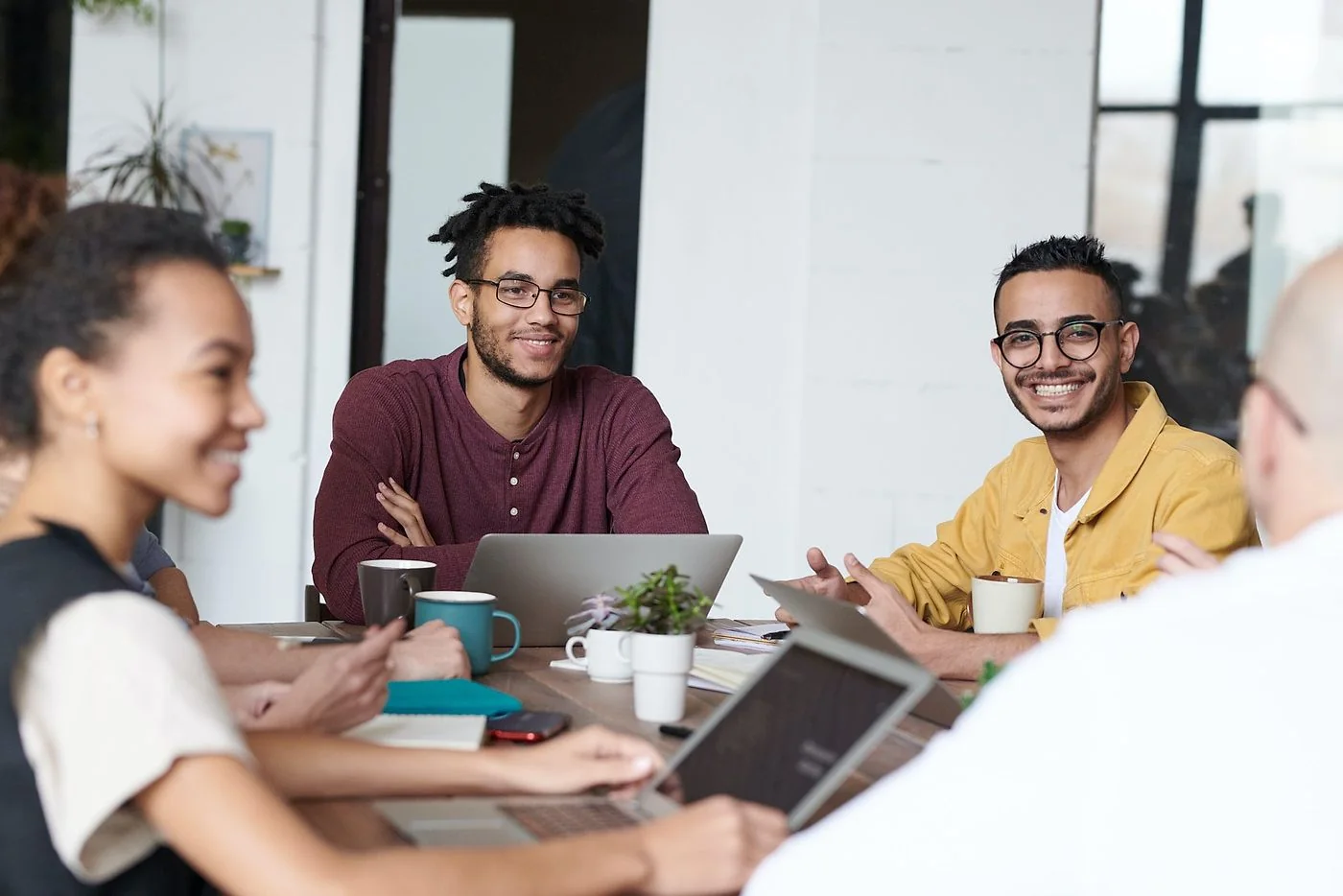 A team talking through work together around a table